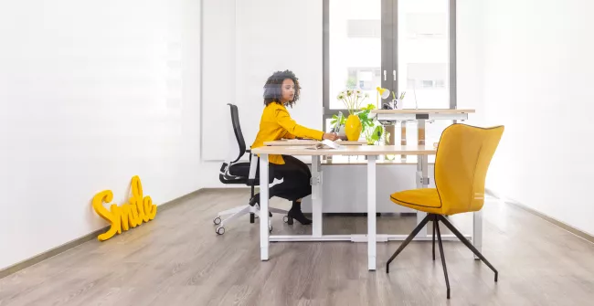 Woman sitting in front of REISS desk