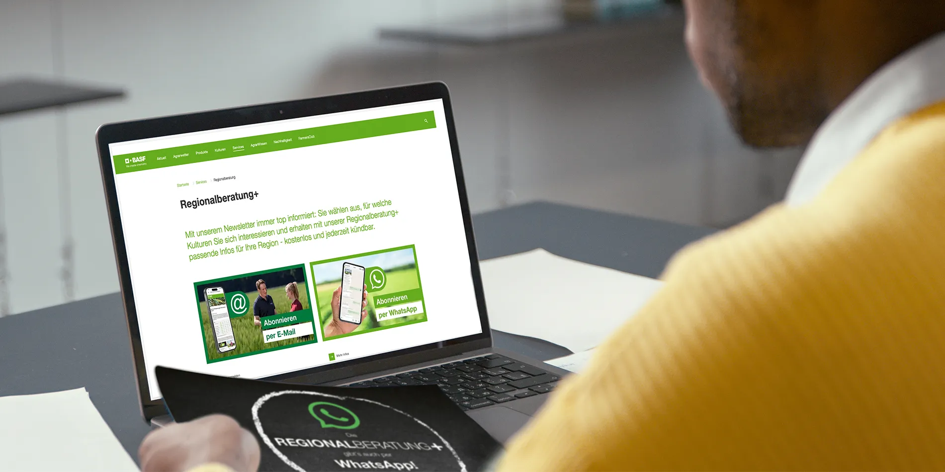 Ein Mann sitzt vor einem Laptop und sieht sich die Website der Regionalberatung an.