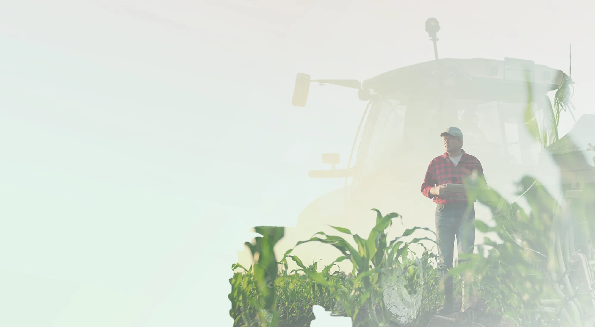 Eine Doppelbelichtigung eines Traktor auf einem Feld und einem Landwirt
