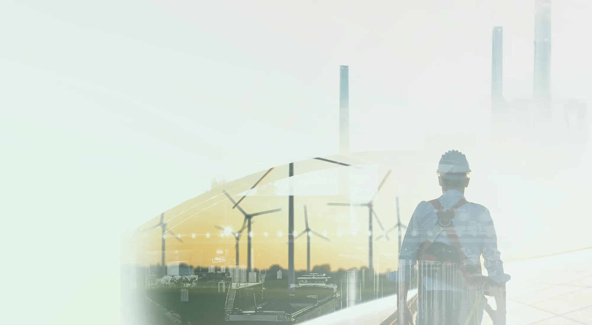 Eine Doppelbelichtung eines Arbeiters mit Helm und Windrädern